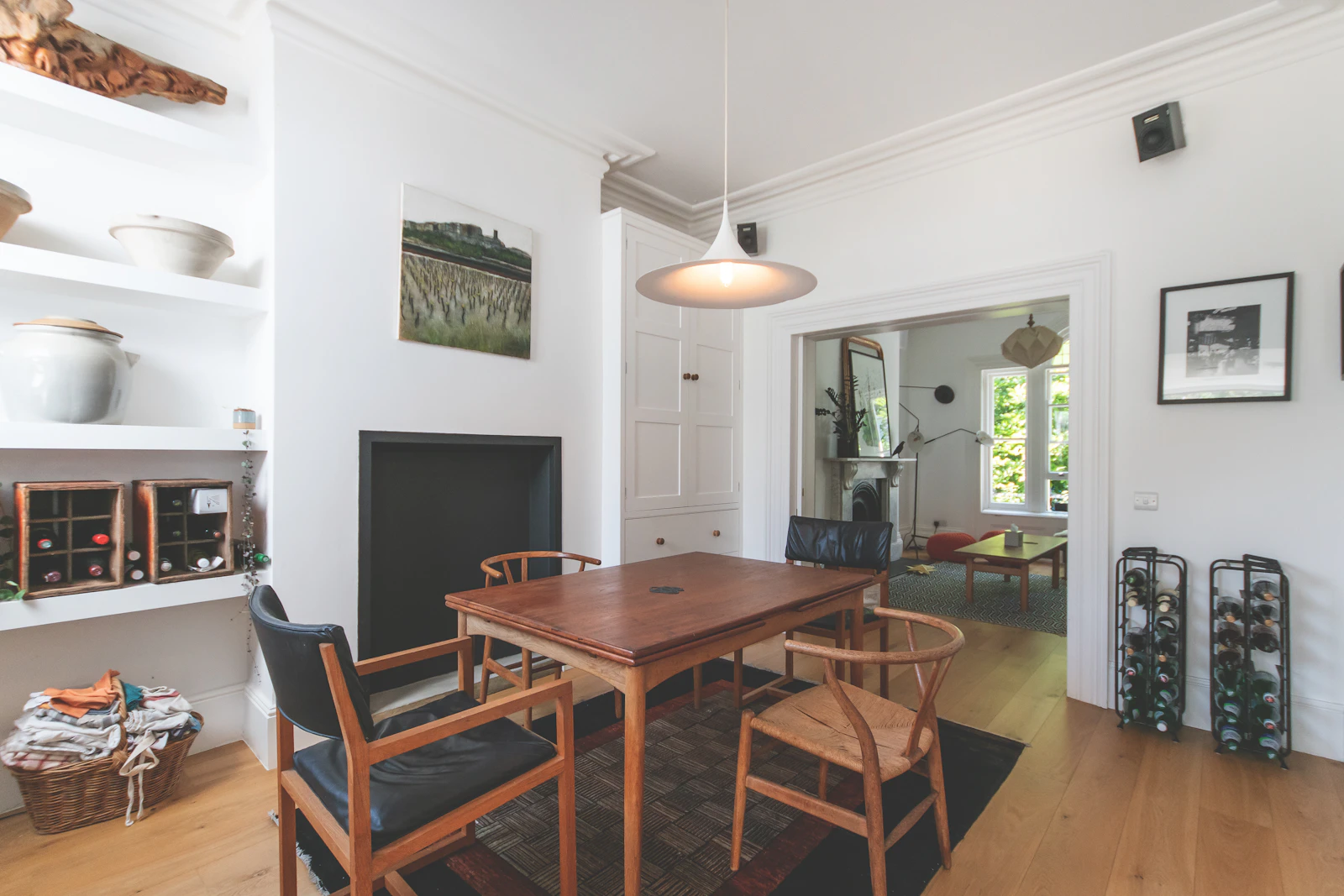 Period London reception room with a fireplace and sash windows