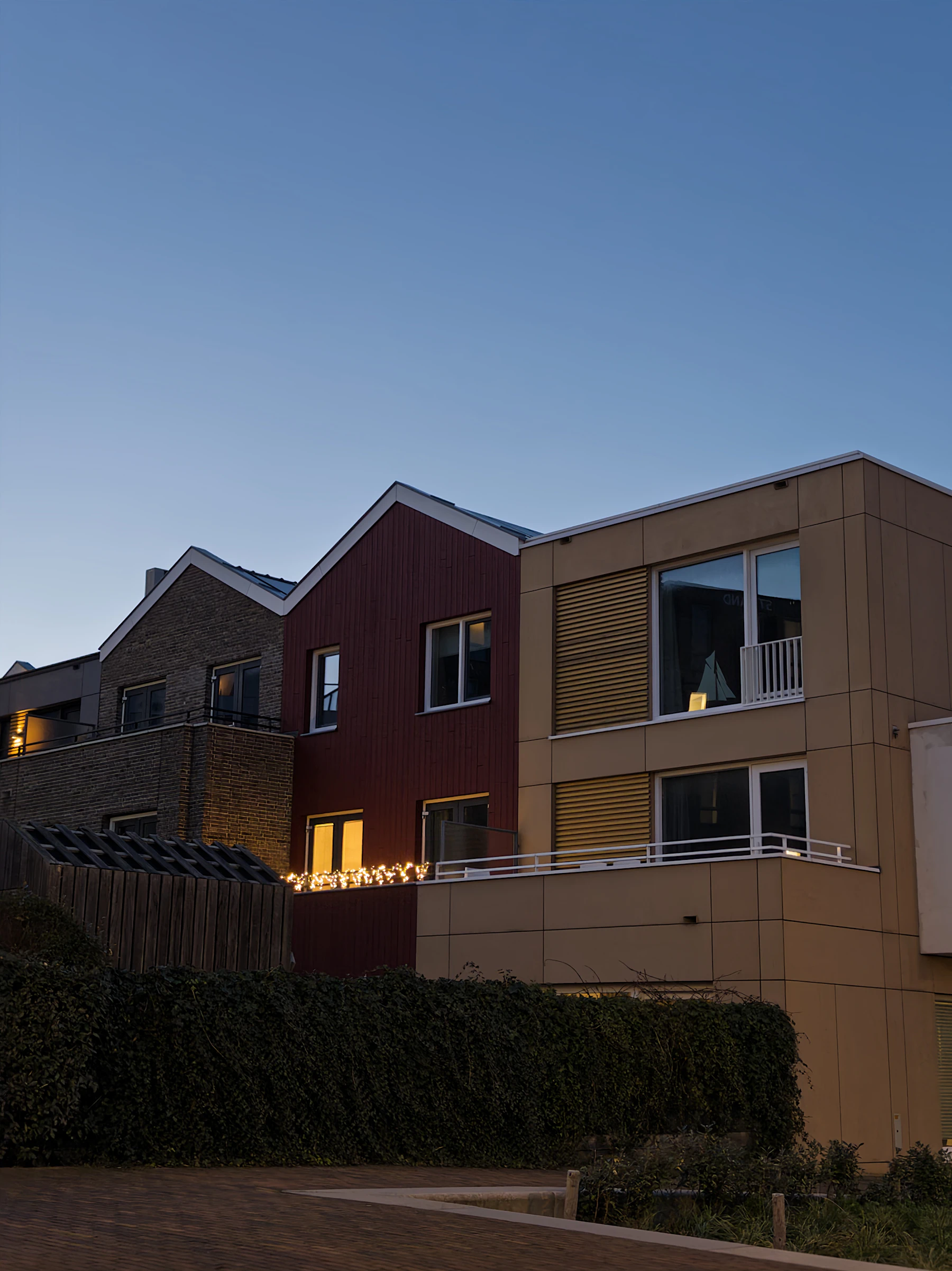 A row of modern townhouses viewed across the street